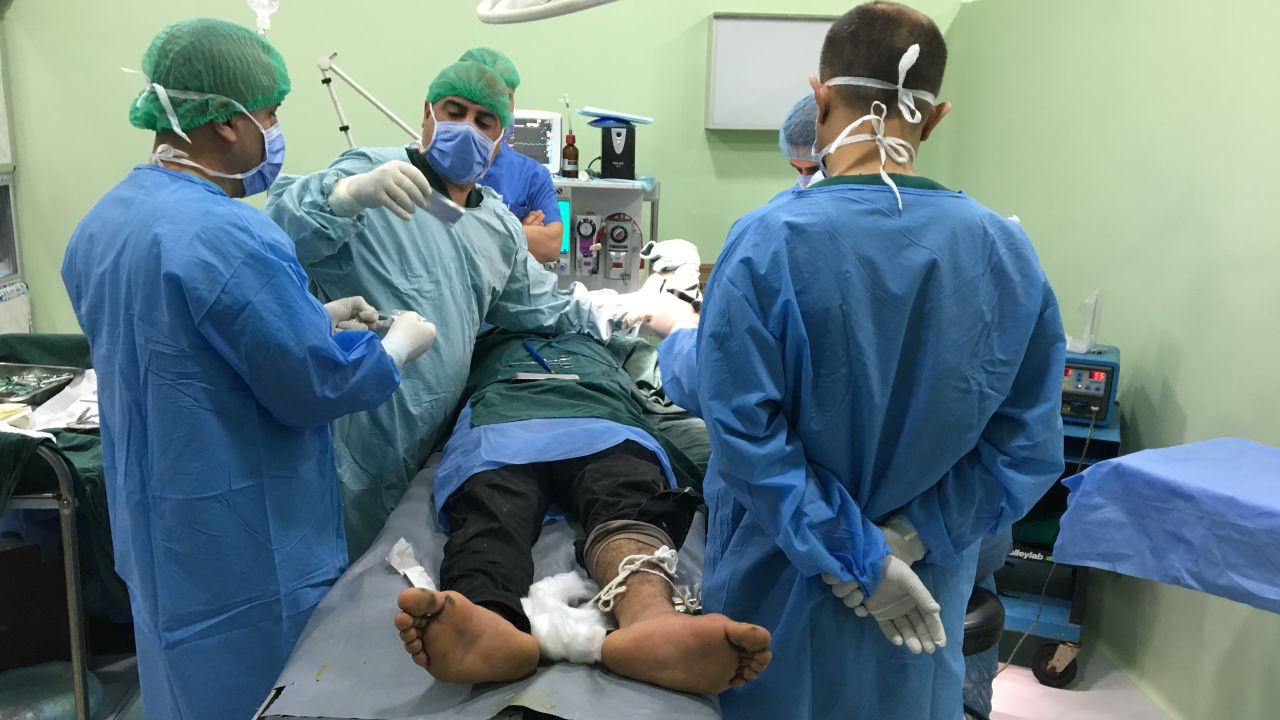 An injured man is treated by surgeons at al Shikan hospital.