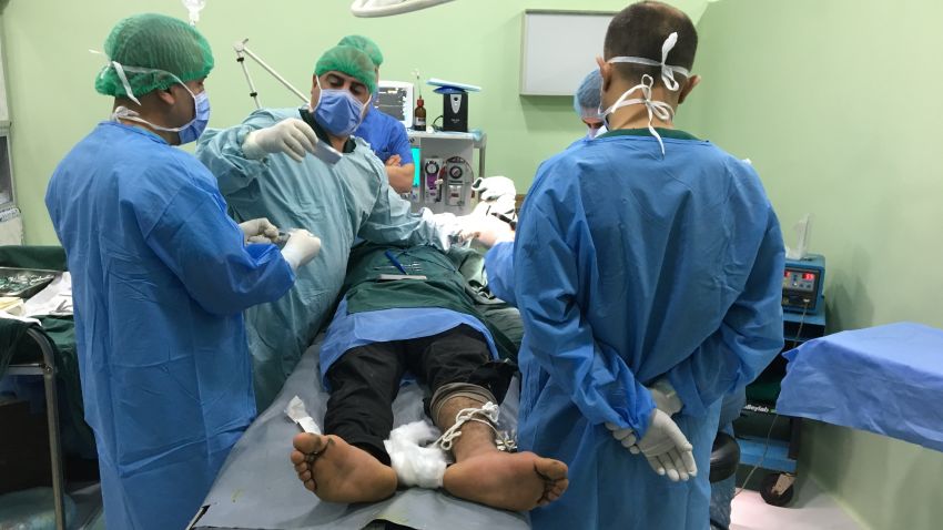 An injured man is treated at al Shikan hospital near Mosul