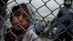 MITILINI, GREECE - OCTOBER 23: A child waits with her father at the migrant processing center at the increasingly overwhelmed Moria camp on the island of Lesbos on October 23, 2015 in Mytilene, Greece. Dozens of rafts and boats are still making the journey daily as thousands flee conflict in Iraq, Syria, Afghanistan and other countries. More than 500,000 migrants have entered Europe so far this year. Of that number four-fifths of have paid to be smuggled by sea to Greece from Turkey, the main transit route into the EU. Nearly all of those entering Greece on a boat from Turkey are from the war zones of Syria, Iraq and Afghanistan. (Photo by Spencer Platt/Getty Images)