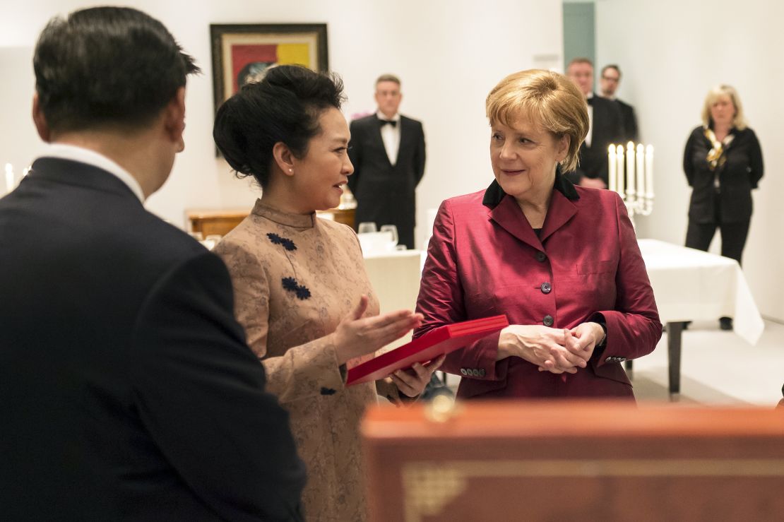 Peng Liyuan meets German Chancellor Angela Merkel wearing one of Ma Ke's designers on March 28, 2014.
