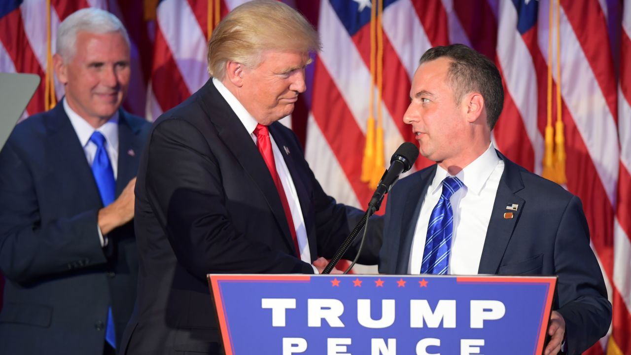 Chairman of the Republican National Committee (RNC) Reince Priebus (R) shakes hands with Republican presidential elect Donald Trump (C) as Republican candidate for Vice President Mike Pence looks on during election night at the New York Hilton Midtown in New York on November 9, 2016.