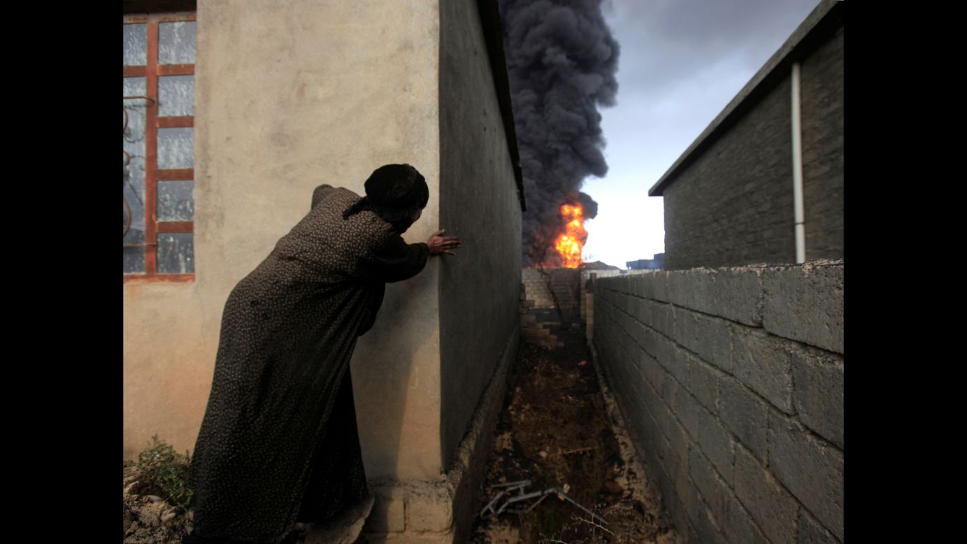 A woman watches oil wells set ablaze by ISIS militants in Qayyara, Iraq, on Friday, November 4. <a href="http://www.cnn.com/2016/11/05/middleeast/iraq-mosul-offensive/index.html" target="_blank">As the fight to retake Mosul from ISIS</a> rages on, ISIS militants have been <a href="http://edition.cnn.com/2016/10/12/world/burning-oil-wells-isis-iraq/" target="_blank">setting oil wells on fire</a> in the hopes of obscuring the views of Iraqi and coalition warplanes.