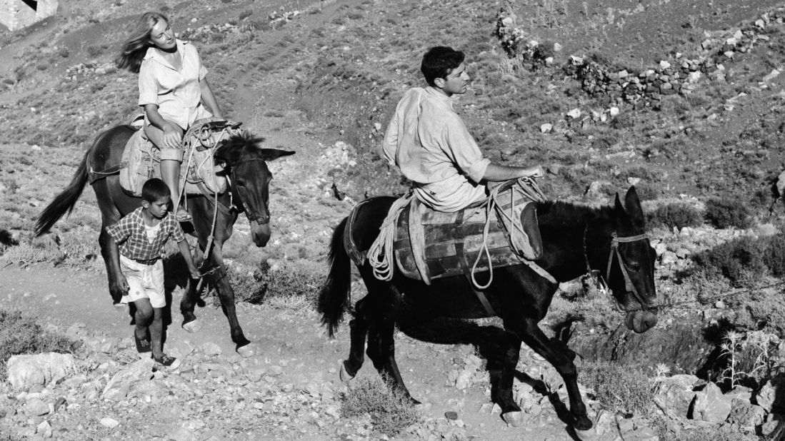 Cohen rides a mule along a stone path in Hydra, Greece, in October 1950. Cohen had bought a house on the island earlier in the year.