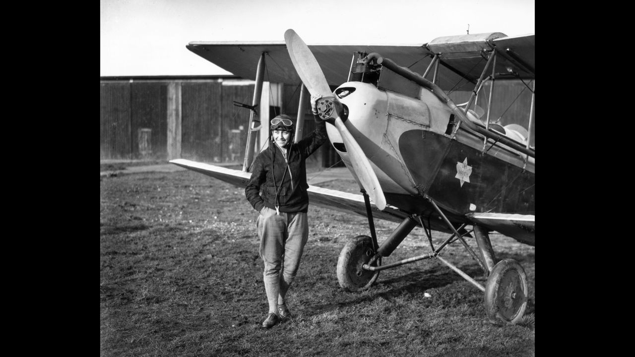 English aviator Amy Johnson standing in front of her Gipsy Moth just before she undertook a 19-day solo flight to Australia.  Johnson was a pioneering English aviator and was the first female pilot to fly alone from Britain to Australia in 1930.