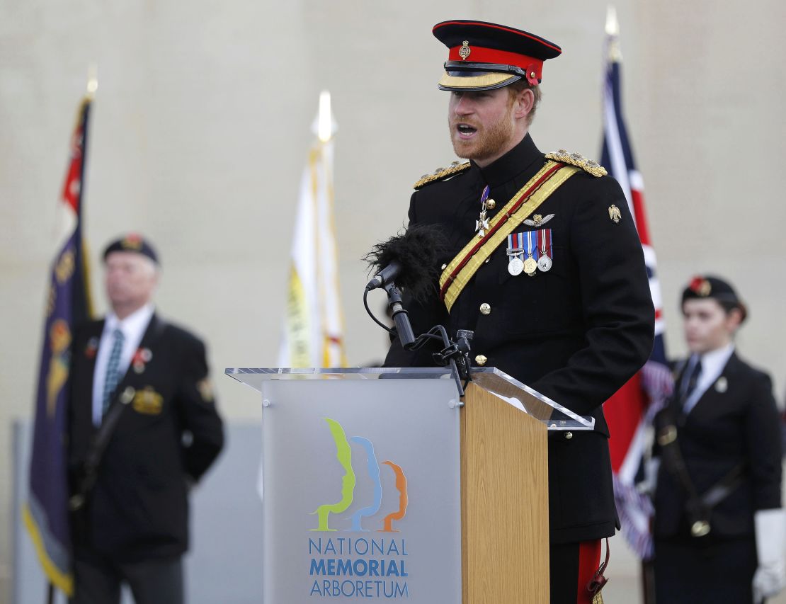 Prince Harry read a war poem after laying a wreath at the Armed Forces Memorial.