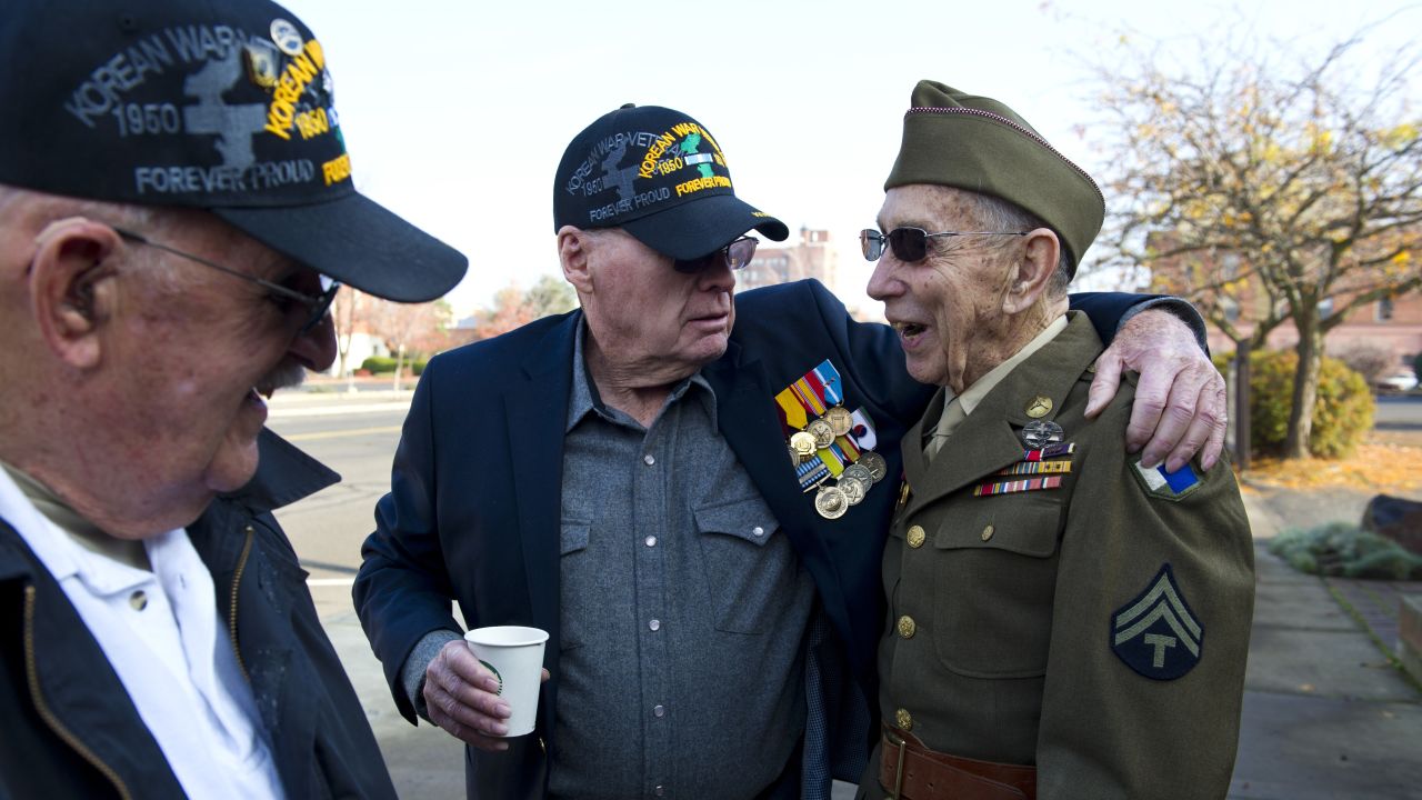 Korean War veterans Ken Silver, left, and Paul Hellie, center, greet four-time Purple Heart recipient Emil Reynold before a Veterans Day parade in Walla Walla, Washington, on November 11.