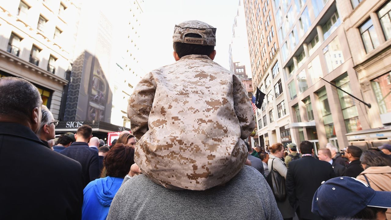 A boy sits on his father's shoulders during the Veterans Day parade in New York on November 11.