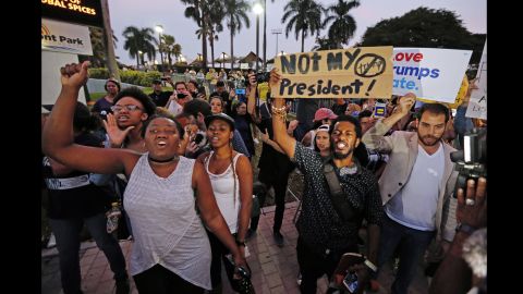 Protesters march Friday at Bayfront Park in Miami. 