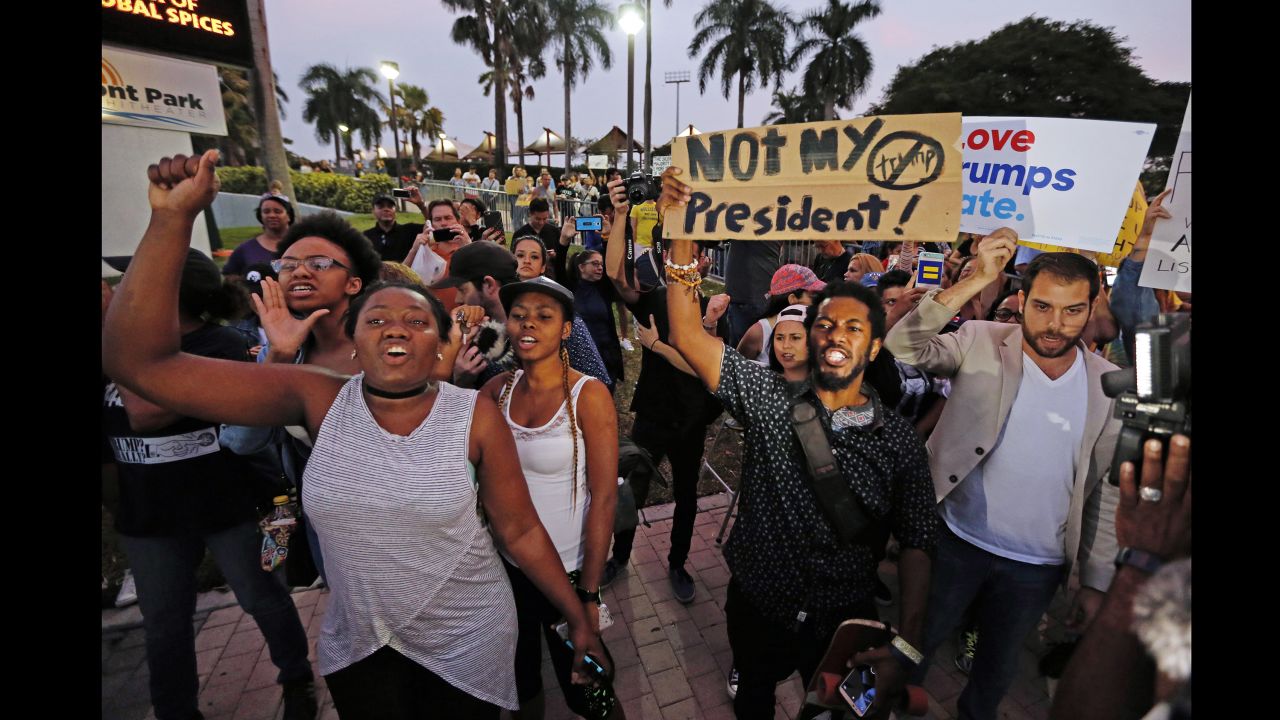 Protesters march Friday at Bayfront Park in Miami.