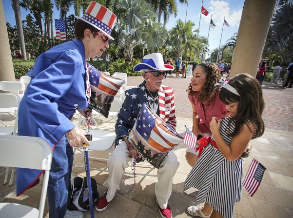 Retired air force veteran E. David Humphreys, 83, and his wife, Patricia, speak with  Ana Dunitz and her daughter Daniela, 5, after a Veterans Day ceremony at Veterans Plaza in Palm Beach Gardens, Florida. 