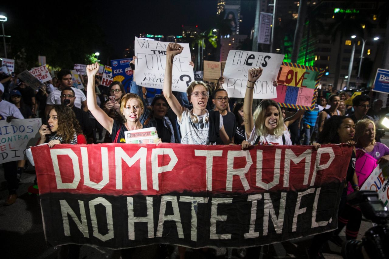People protest Trump during a march in downtown Miami on Friday, November 11.