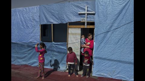 Many families have decorated their temporary homes, made from shipping containers, with crosses, as if to signal their distress and show their resolve for their faith.