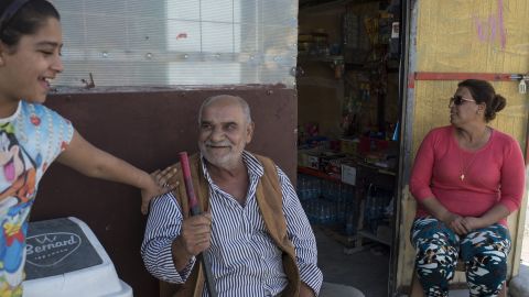 Raja Paulous, 46, right, runs a small grocery at Ashti camp. Back home in Qaraqosh, she had a grocery service and led a happy life. She can't find it in her heart to forgive ISIS for destroying her life.