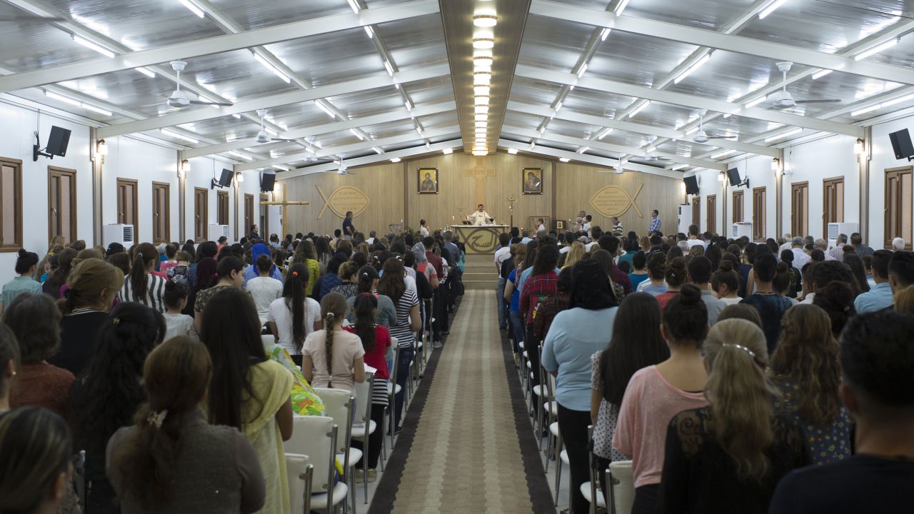 Iraqi Christians displaced from their homes for more than two years attend church on a Sunday evening at a camp in Irbil.