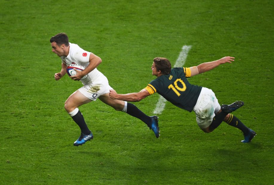 George Ford goes past a tackle by Pat Lambie of South Africa to score his team's third try at Twickenham.