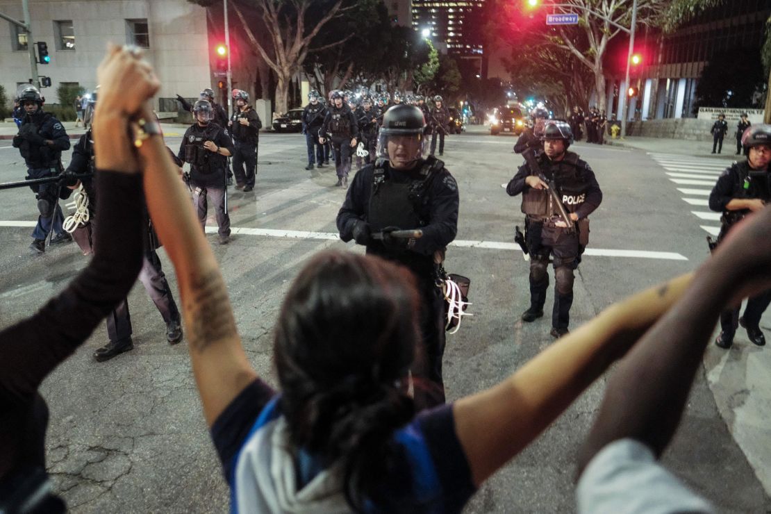 Police confront demonstrators outside City Hall in Los Angeles on Sunday.