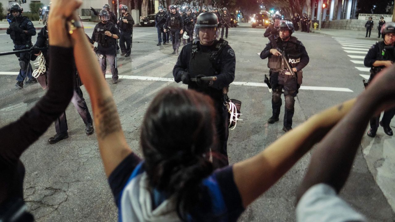 Police confront demonstrators outside City Hall in Los Angeles on Sunday.