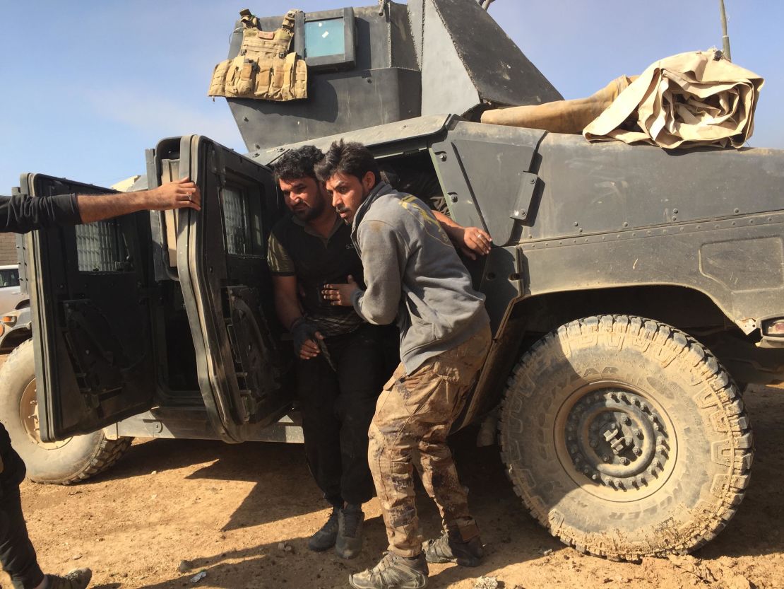 A wounded soldier is pulled out of his armored Humvee after returning from the front line.