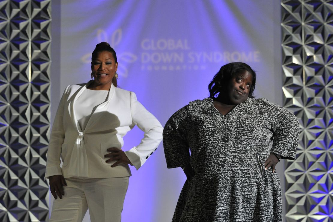 Queen Latifah walks the runway with DeOndra Dixon during the 2016 Global Down Syndrome Foundation "Be Beautiful, Be Yourself" fashion show.