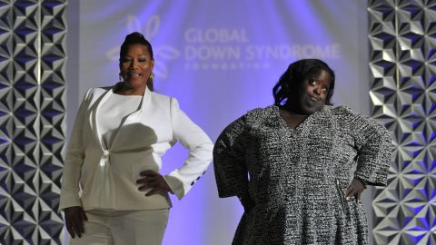 Queen Latifah walks the runway with DeOndra Dixon during the 2016 Global Down Syndrome Foundation "Be Beautiful, Be Yourself" fashion show.