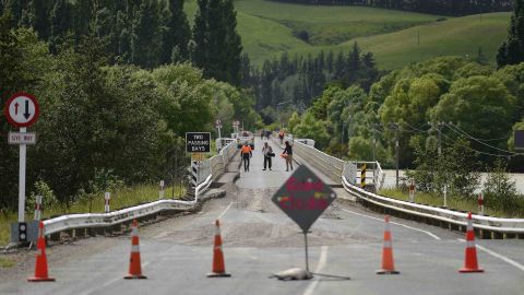 Emergency services inspect a bridge crossing the Waiau River, 110 kms north of Christchurch, as damage and land slip cause infrastructure disruption in the aftermath of a 7.5 magnitude earthquake.