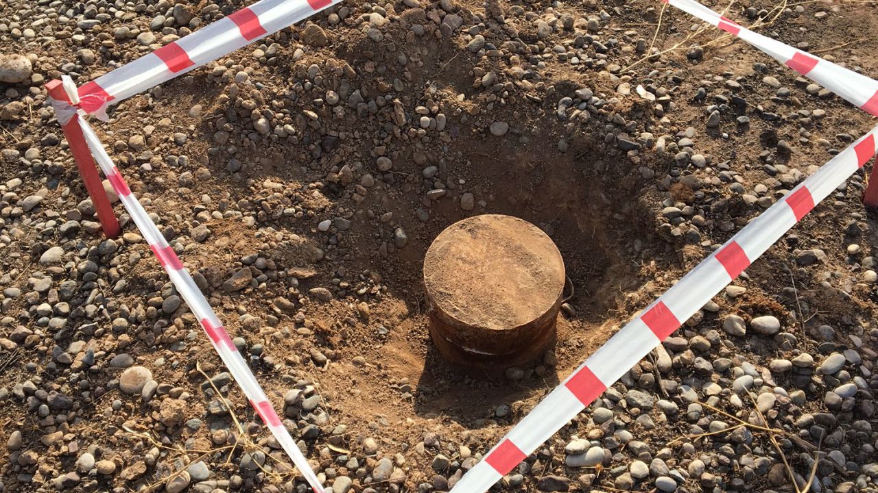 An unexploded mine is sectioned off by the MAG.
