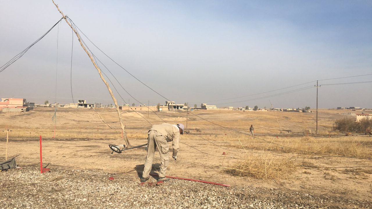 A worker from the Mines Advisory Group scans fields for bombs.