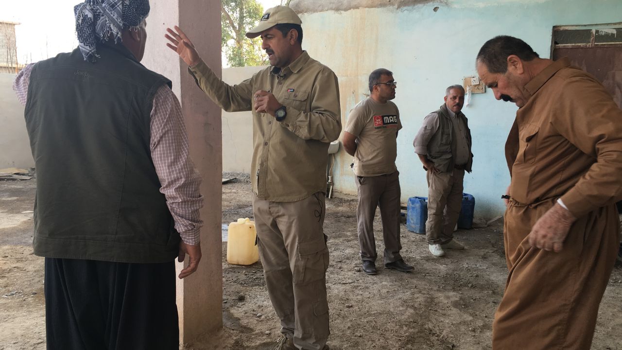 Salaam Muhmmed from the Mines Advisory Group speaks to villagers about MAG's progress in clearing the mines.