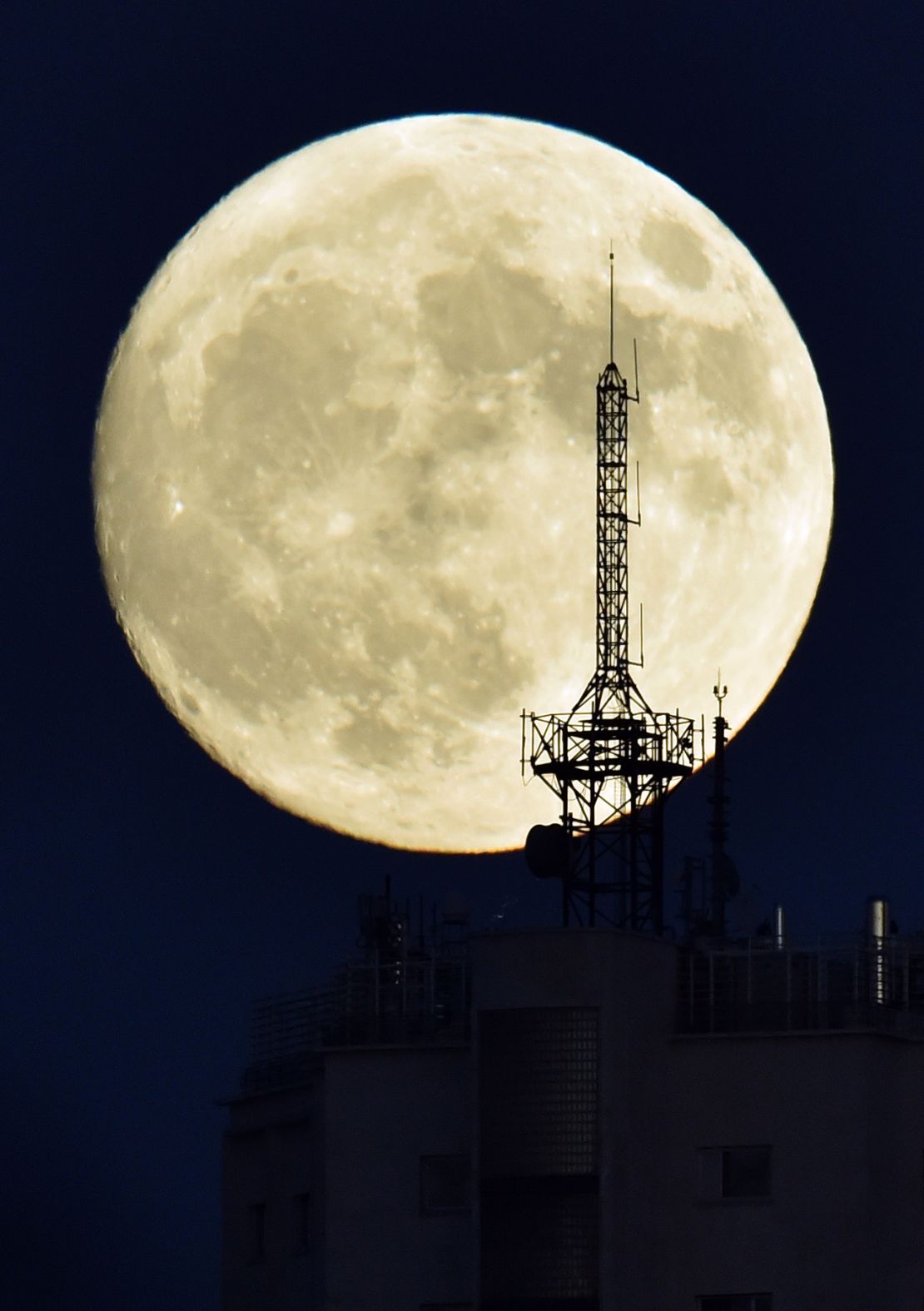 The moon rises over a building in Madrid on November 13, 2016, on the eve of the "supermoon."
 