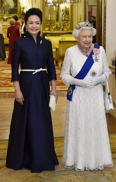 Peng Liyuan, on the left, with Britain's Queen Elizabeth II, arrive for a state banquet at Buckingham Palace in London, England in 2015. "My philosophy for the First Lady's designs is elegance, subtlety and demureness," Ma says.