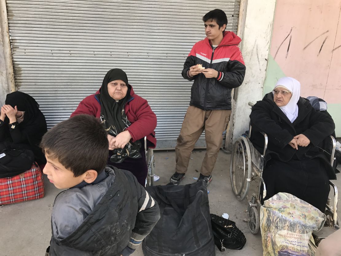 56-year-old Hasnaah Mohammed, pictured second from left in a red fleece, left the battle for Mosul behind with four children. 