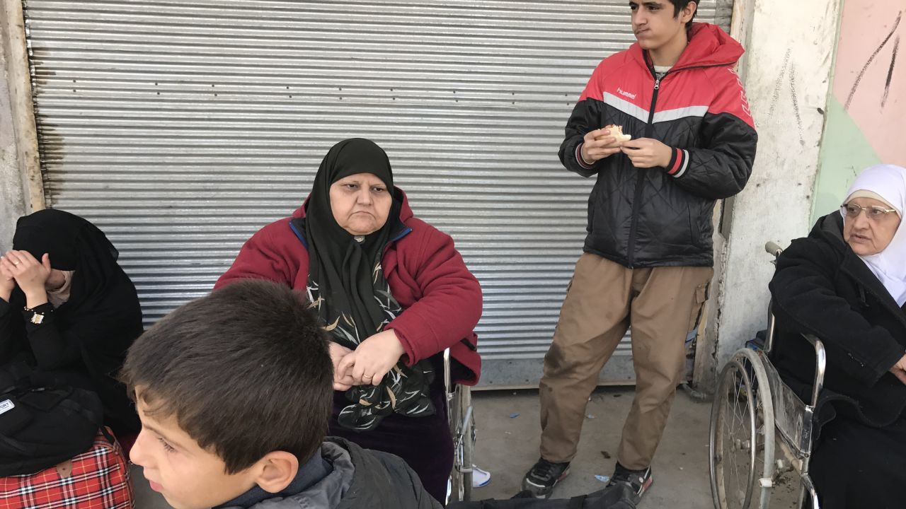 56-year-old Hasnaah Mohammed, pictured second from left in a red fleece, left the battle for Mosul behind with four children.