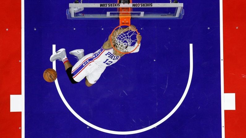 Philadelphia's Gerald Henderson hangs on the rim after dunking against Indiana on Friday, November 11. The 76ers won their first game of the NBA season after losing their first seven.