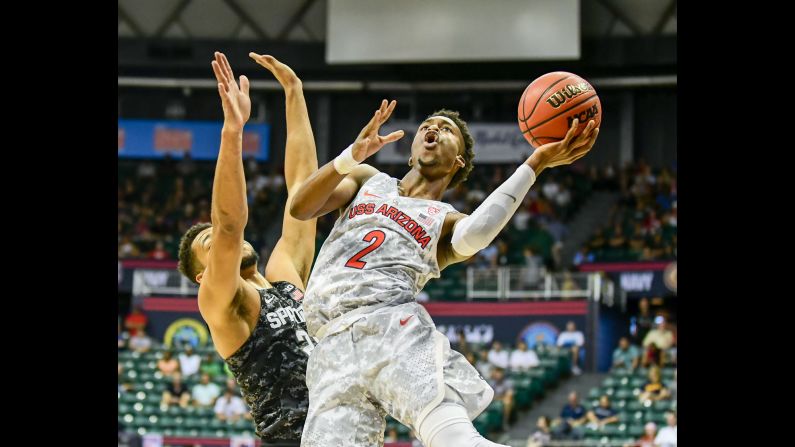 Arizona guard Kobi Simmons is defended by Michigan State's Kenny Goins during the Armed Forces Classic, the two teams' season opener on Friday, November 11. Arizona won 65-63 with a late basket by Kadeem Allen.