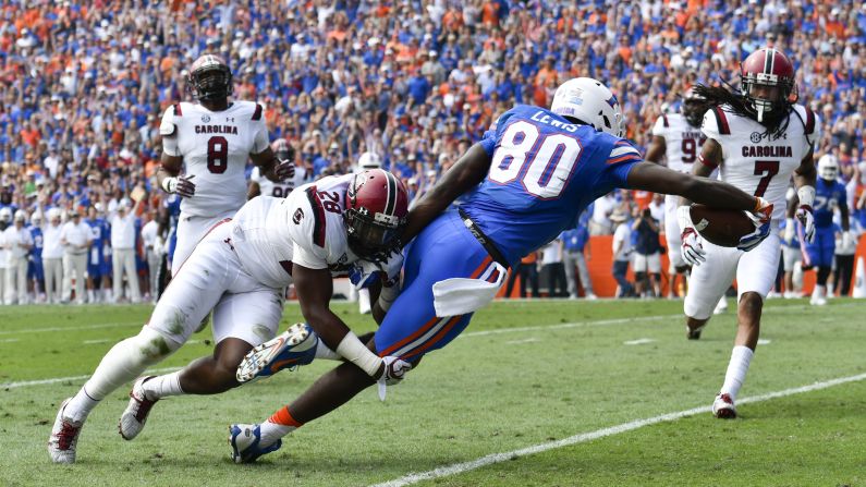 Florida's C'yontai Lewis drags South Carolina's Jonathan Walton into the end zone during a college football game in Gainesville, Florida, on Saturday, November 12. Florida won 20-7 against former head coach Will Muschamp.