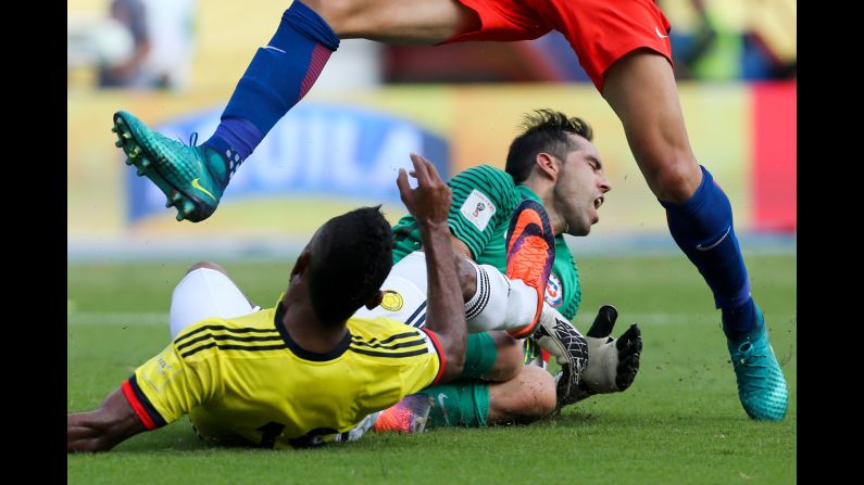 Colombia's Miguel Borja, left, collides with Chile goalkeeper Claudio Bravo during a World Cup qualifier in Barranquilla, Colombia, on Thursday, November 10. The match ended scoreless.