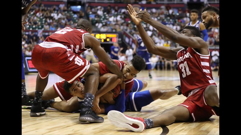 Kansas' Landen Lucas is mobbed by Indiana players as they compete for a loose ball on Friday, November 11.