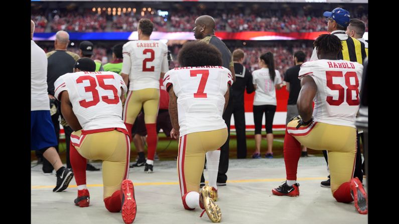 From left, San Francisco 49ers Eric Reid, Colin Kaepernick and Eli Harold kneel during the national anthem on Sunday, November 13. After the game in Arizona, Kaepernick explained to the media <a href="index.php?page=&url=http%3A%2F%2Fwww.cnn.com%2F2016%2F11%2F14%2Fsport%2F49ers-qb-colin-kaepernick-explains-why-he-didnt-vote%2Findex.html" target="_blank">why he didn't vote</a> in the presidential election. "You know, I think it would be hypocritical of me to vote," said Kaepernick, who began protesting the anthem in August. "I said from the beginning I was against oppression, I was against the system of oppression. I'm not going to show support for that system. And to me, the oppressor isn't going to allow you to vote your way out of your oppression." <a href="index.php?page=&url=http%3A%2F%2Fwww.cnn.com%2F2016%2F11%2F07%2Fsport%2Fgallery%2Fwhat-a-shot-sports-1108%2Findex.html" target="_blank">See 25 amazing sports photos from last week</a>