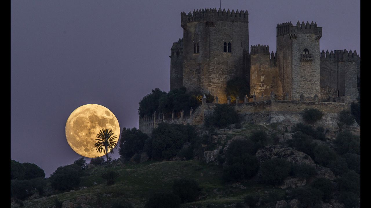The moon rises behind the Almodovar castle in Cordoba, Spain, on Sunday, November 13.