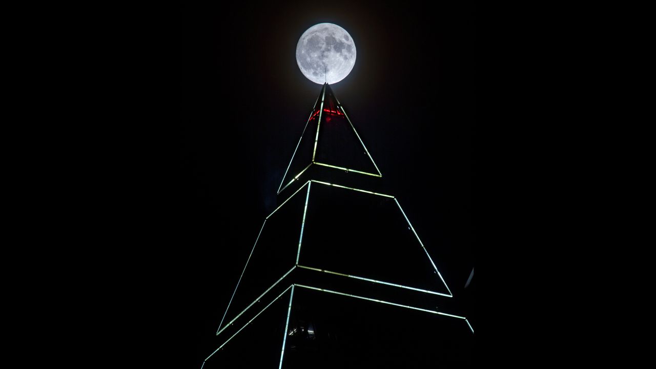 The supermoon appears behind the MesseTurm tower in Frankfurt, Germany, on November 13.
