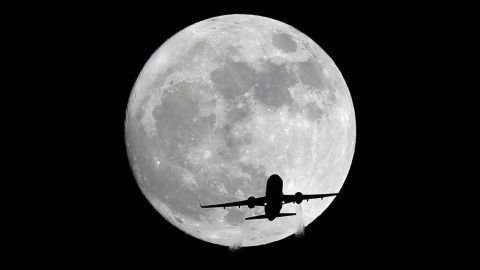 A passenger plane passes in front of the moon, as seen from Whittier, California, on November 13.