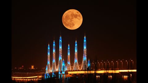 The moon appears over the Binhe Yellow River Bridge in Yinchuan, China, on November 14.