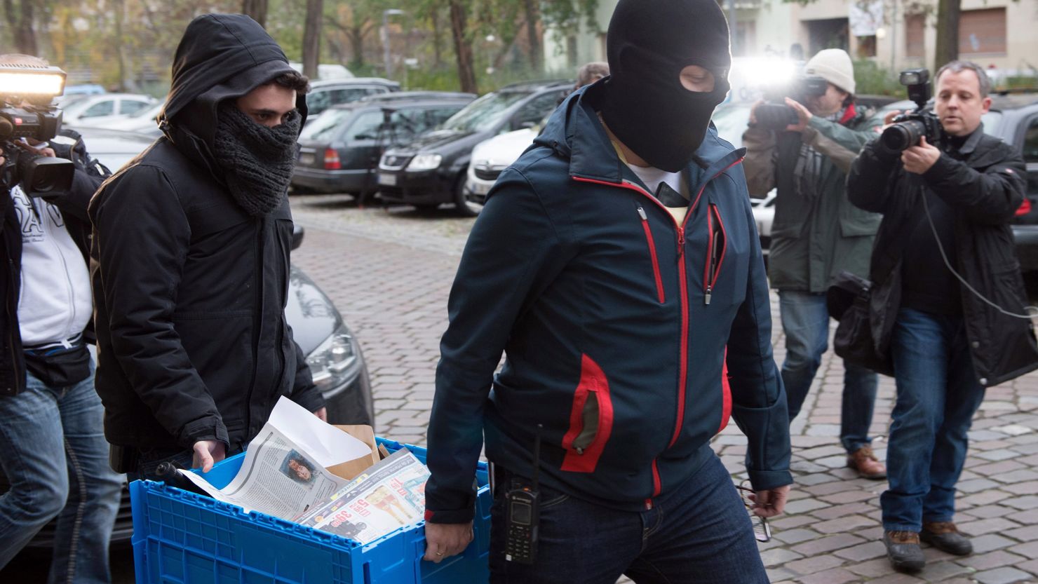 Police officers seize evidence in a raid on The True Religion Islamist organization in Berlin on Tuesday.