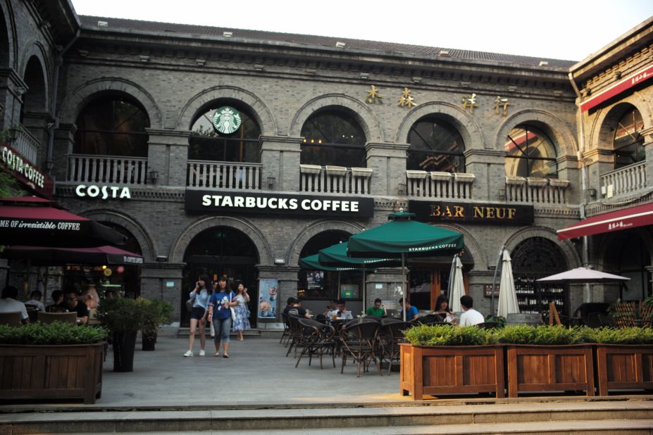 In a commercial and nightlife district next to the palace, named after the year the Republic of China was established, major foreign chains like Starbucks and KFC are housed in historic, gray-brick Republican-era buildings.