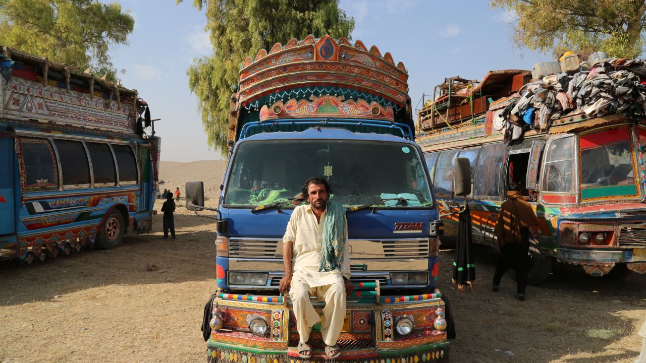 Mohammad Akhbar poses on his rented truck at a UNHCR camp in Nangarhar province after making the week long journey from his home in Pakistan's Khyber Pakhtunkhwa to Afghanistan.
