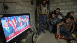 Members of the Iraqi forces watch Donald Trump giving a speech after he won the US president elections in the village of Arbid on the southern outskirts of Mosul on November 9, 2016, as they rest in a house during the ongoing military operation to retake Mosul from the Islamic State (IS) group.