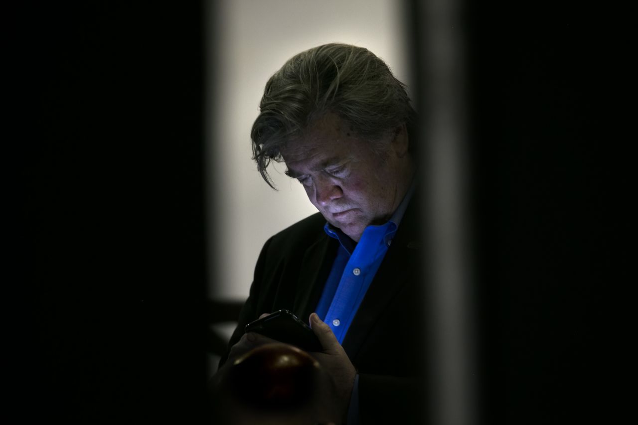 Bannon checks his phone backstage at a Trump rally in Jacksonville, Florida, in November 2016.