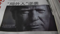 A Chinese newspaper is on sale, with the headline that reads "Outsider strikes back", featuring Donald Trump on the front page in Beijing on November 10, 2016.
The American public on November 9 voted for the Republican candidate Donald Trump to be the 45th President of the United States.  / AFP / GREG BAKER        (Photo credit should read GREG BAKER/AFP/Getty Images)