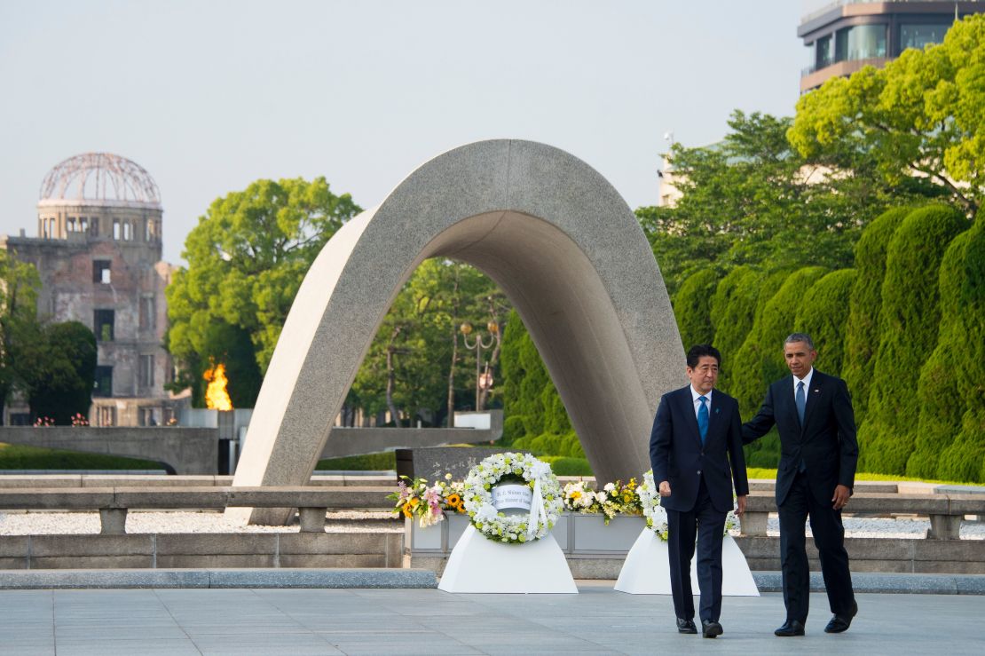 Barack Obama and Japanese Prime Minister Shinzo Abe turn around after laying wreaths to commemorate the victims of the world's first nuclear attacks during a visit to the Hiroshima Peace Memorial Park on May 27, 2016. 