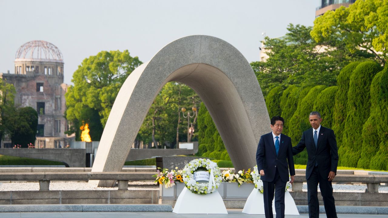 Barack Obama and Japanese Prime Minister Shinzo Abe turn around after laying wreaths to commemorate the victims of the world's first nuclear attacks during a visit to the Hiroshima Peace Memorial Park on May 27, 2016.